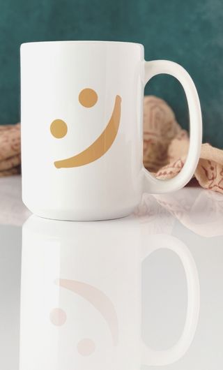 White mug with orange smiley face